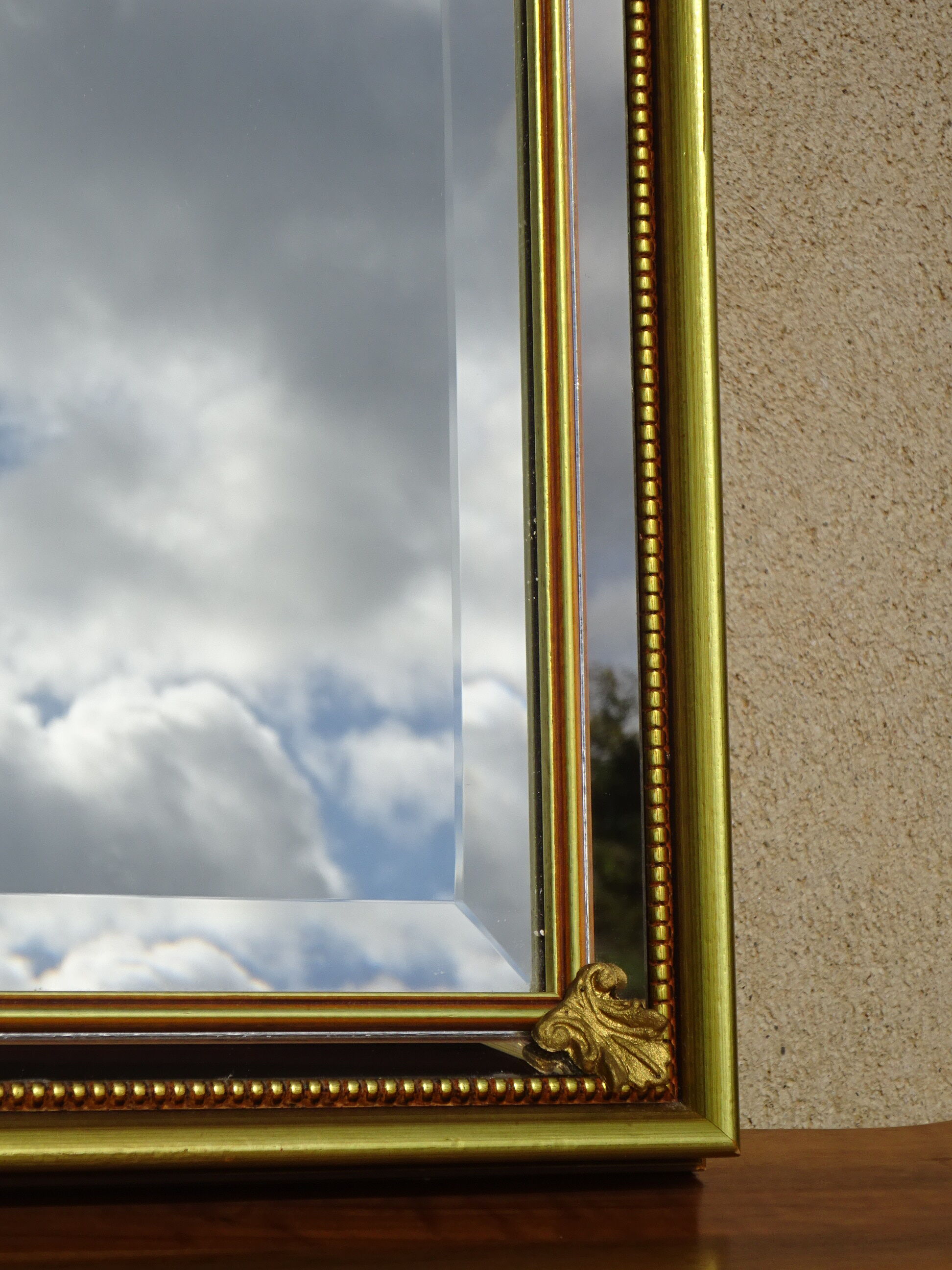 Vertical mirror, gold frame with beading.