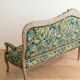 Louis XV bench reupholstered with a green tropical pattern.