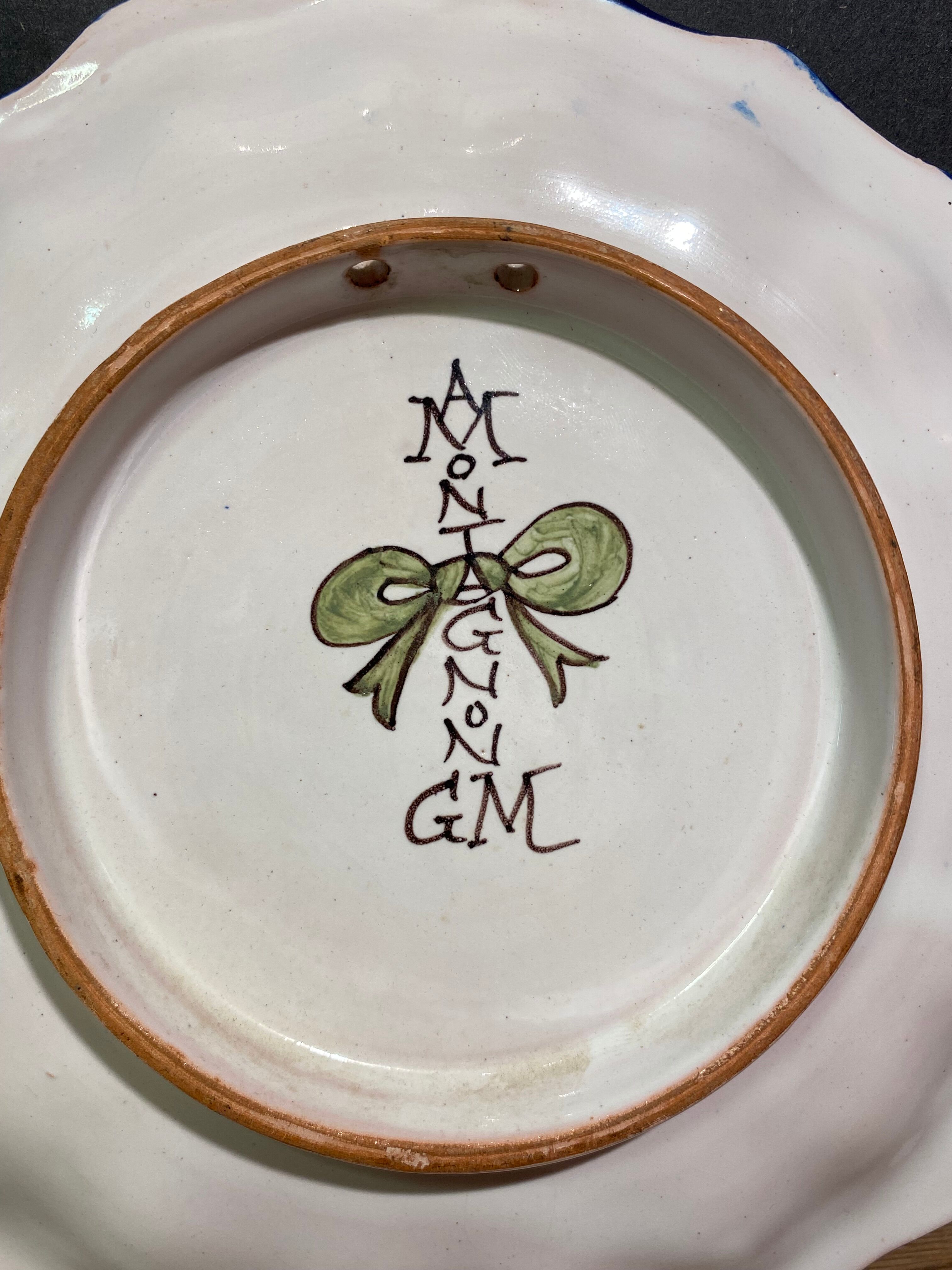 Pair of plates with floral decoration in Nevers earthenware signed Montagnon