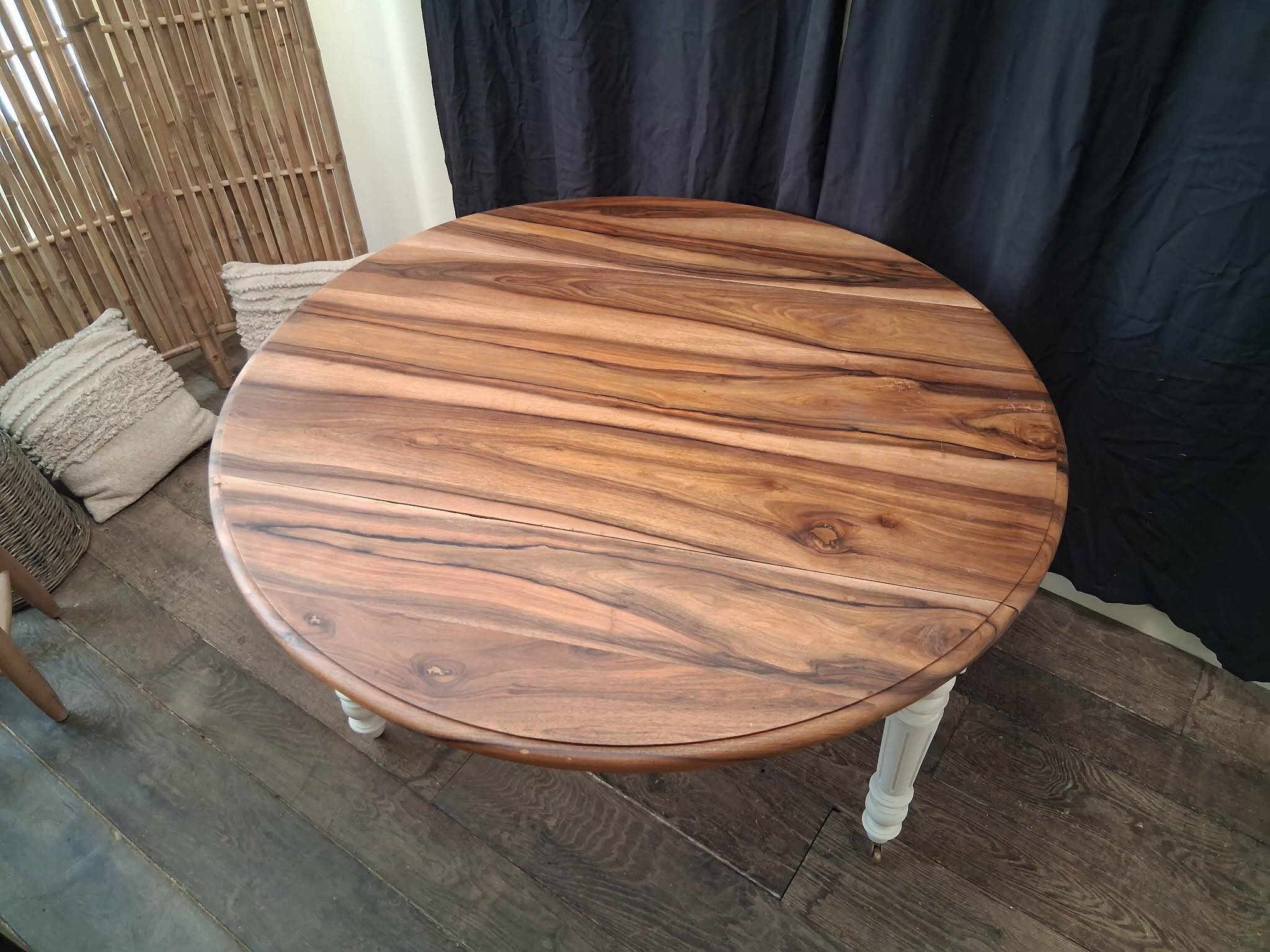 Round walnut table convertible into a console.