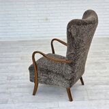 1960s, reupholstered Danish armchair, with stool, genuine sheepskin.