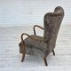 1960s, reupholstered Danish armchair, with stool, genuine sheepskin.