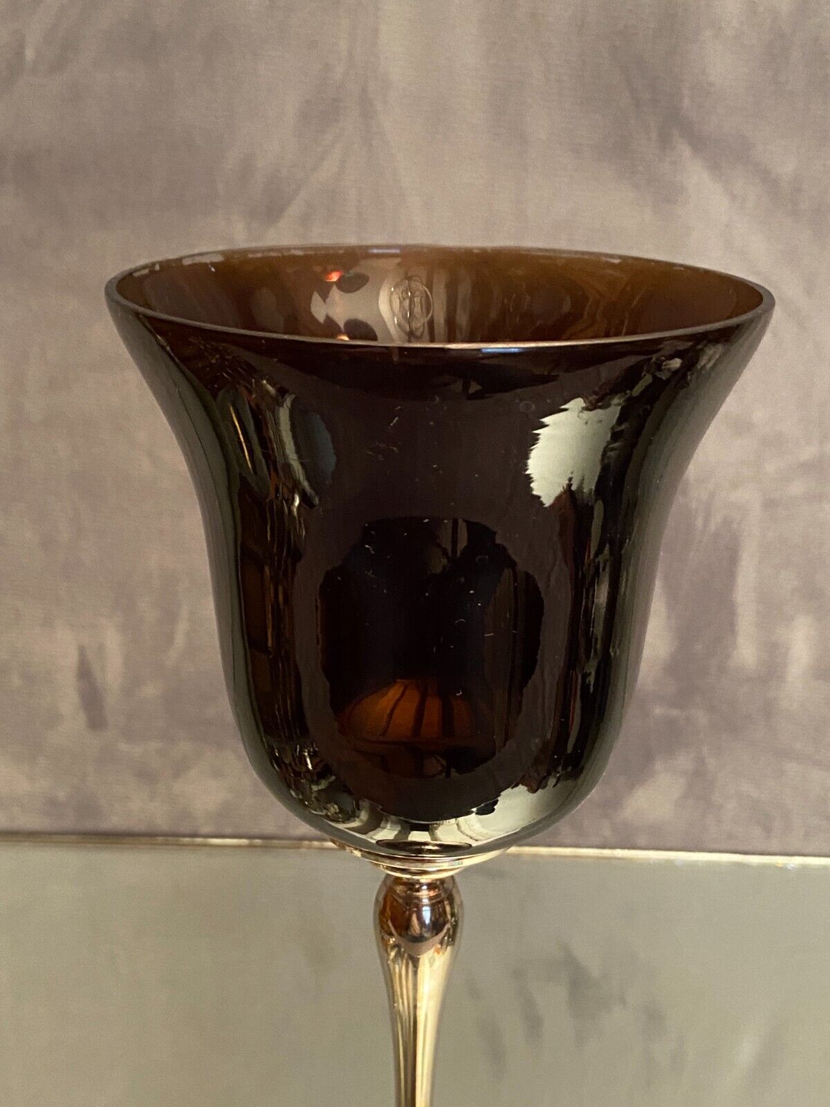 Tinted glass photophore on high metal foot with silver patina