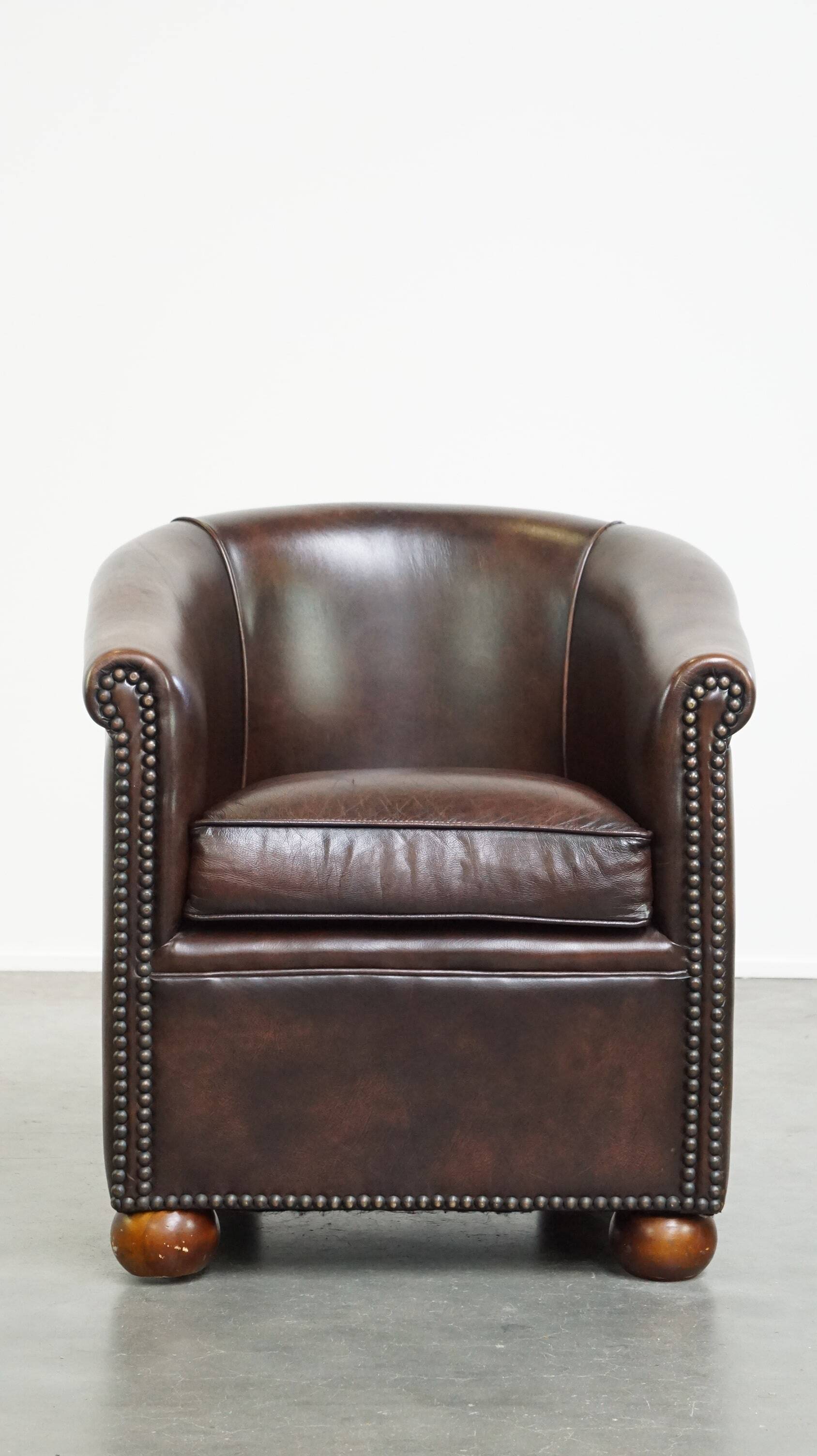 luxury dark leather club chair with English-style ball feet