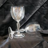 A pair of engraved crystal wine glasses