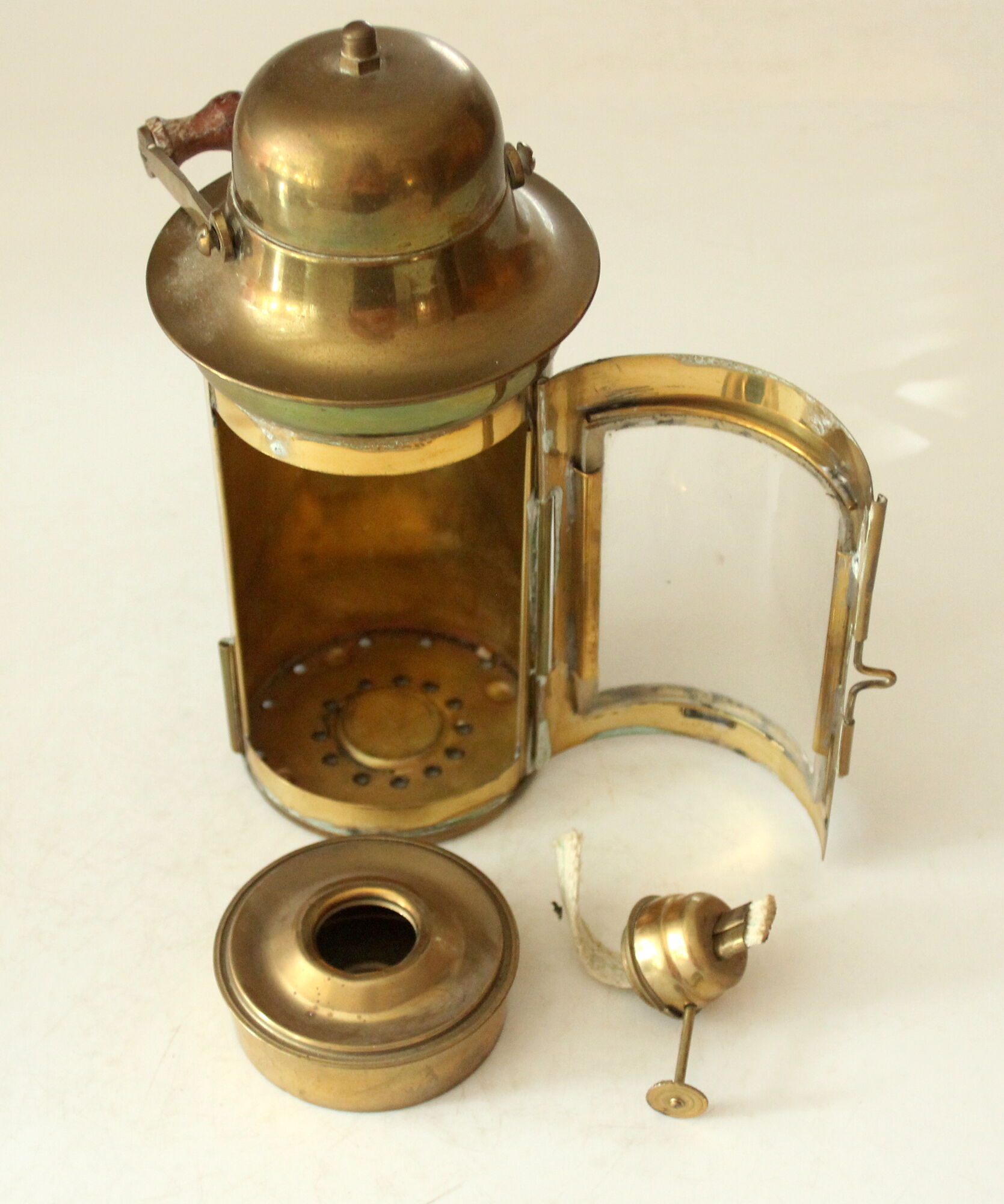 Decorative brass and glass oil lamp, wind light with wooden handle, vintage from the 1970s
