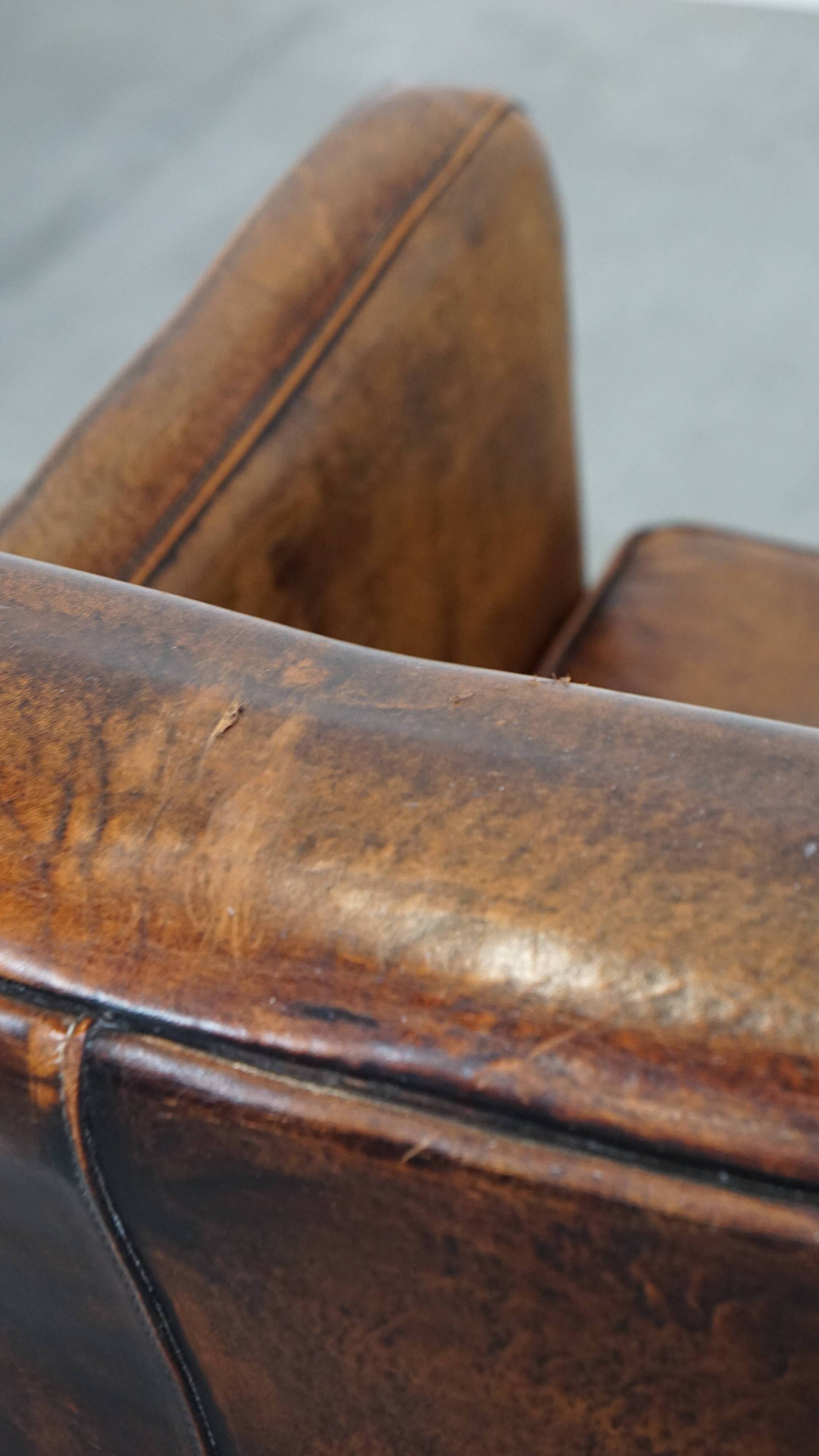 Dark brown design armchair made of sheepskin leather