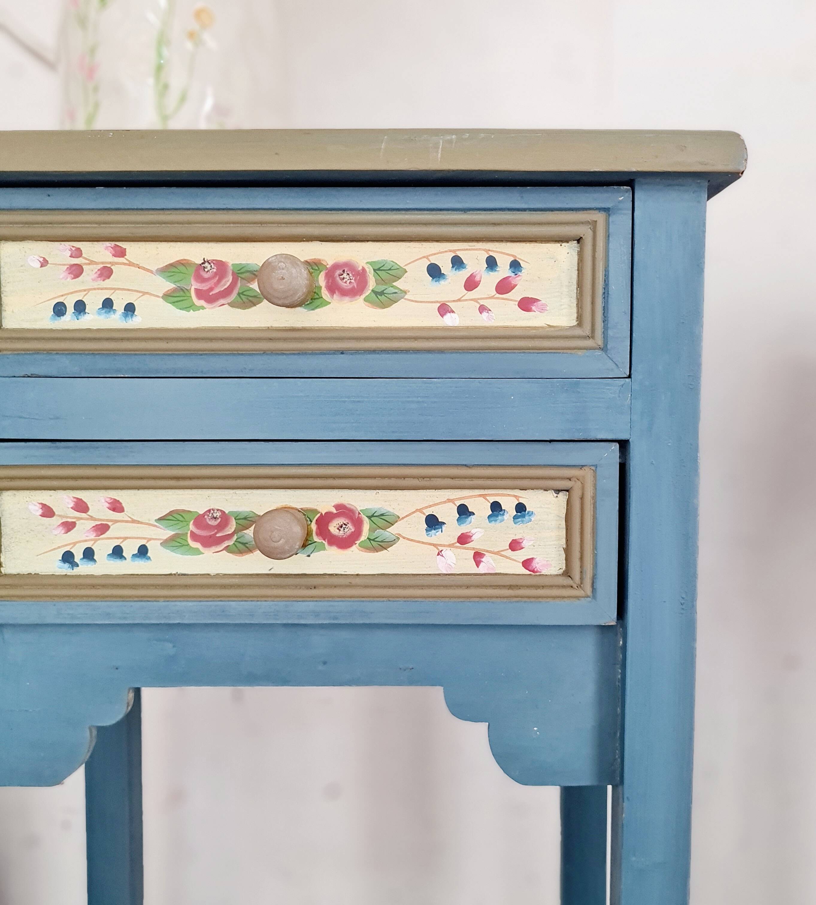 Blue wooden bedside tables with floral patterns