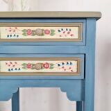 Blue wooden bedside tables with floral patterns