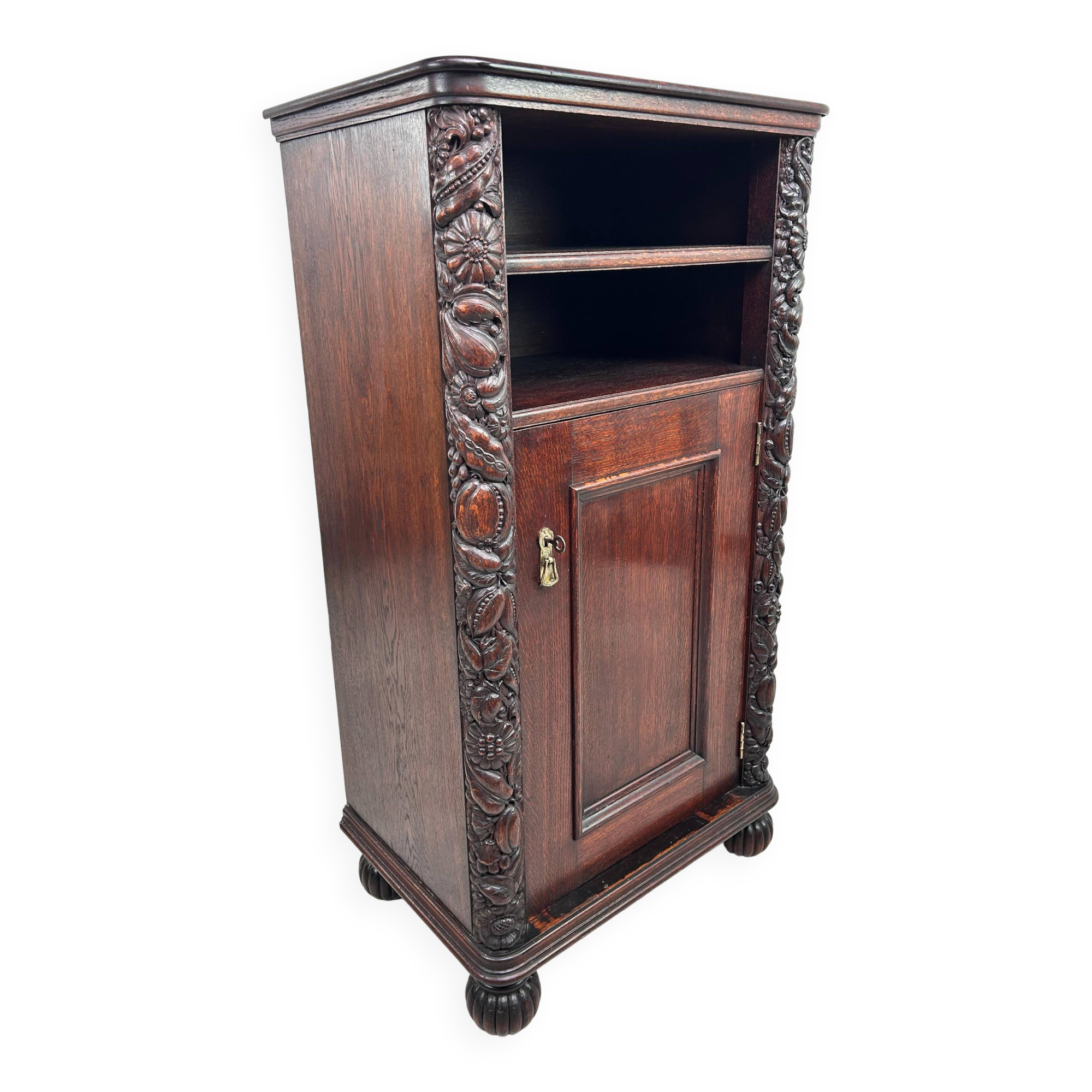 Art Nouveau cabinet with a shelf featuring distinctive floral sculptures.
