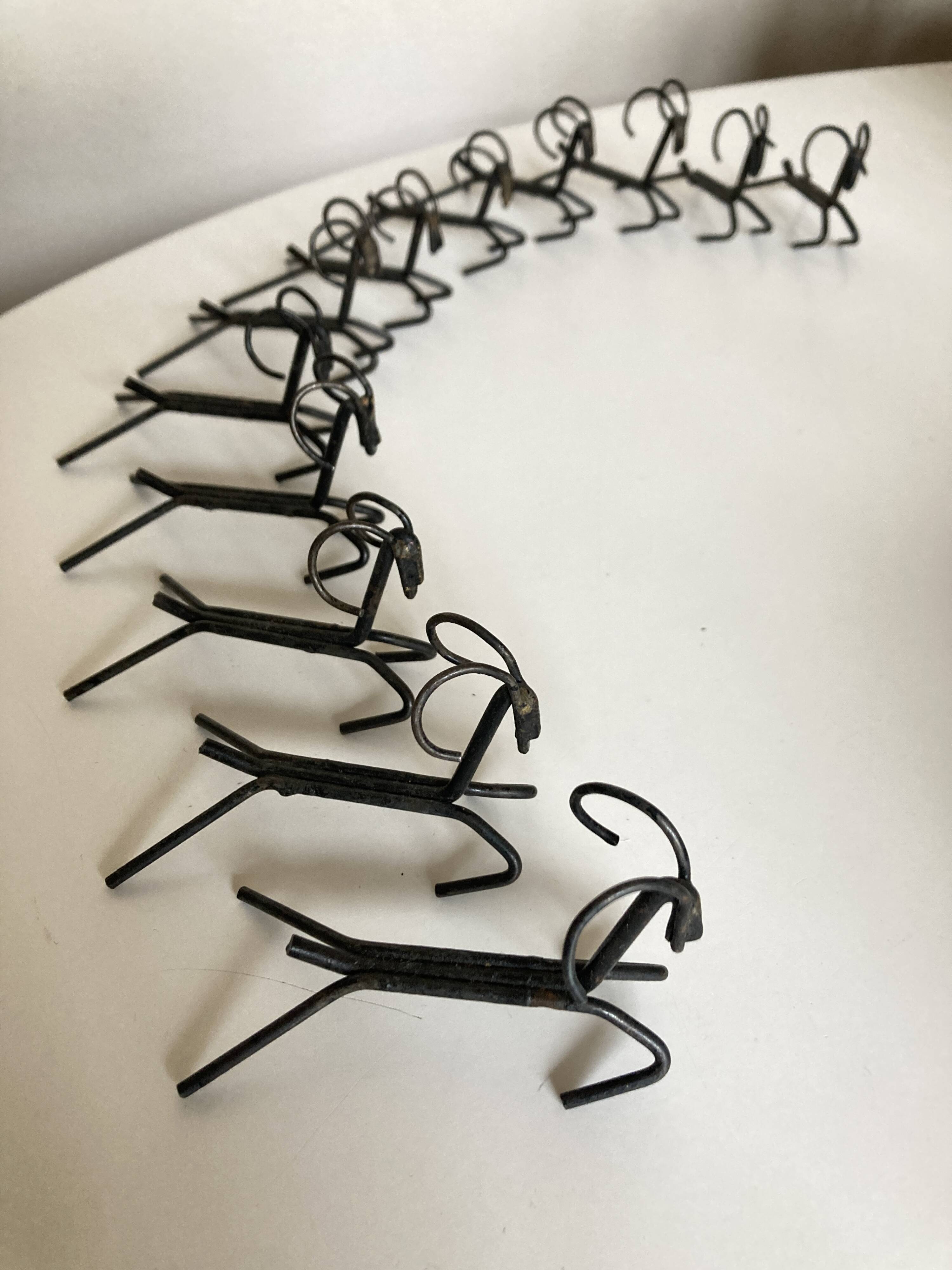 Set of 12 raw iron knife rests 1970