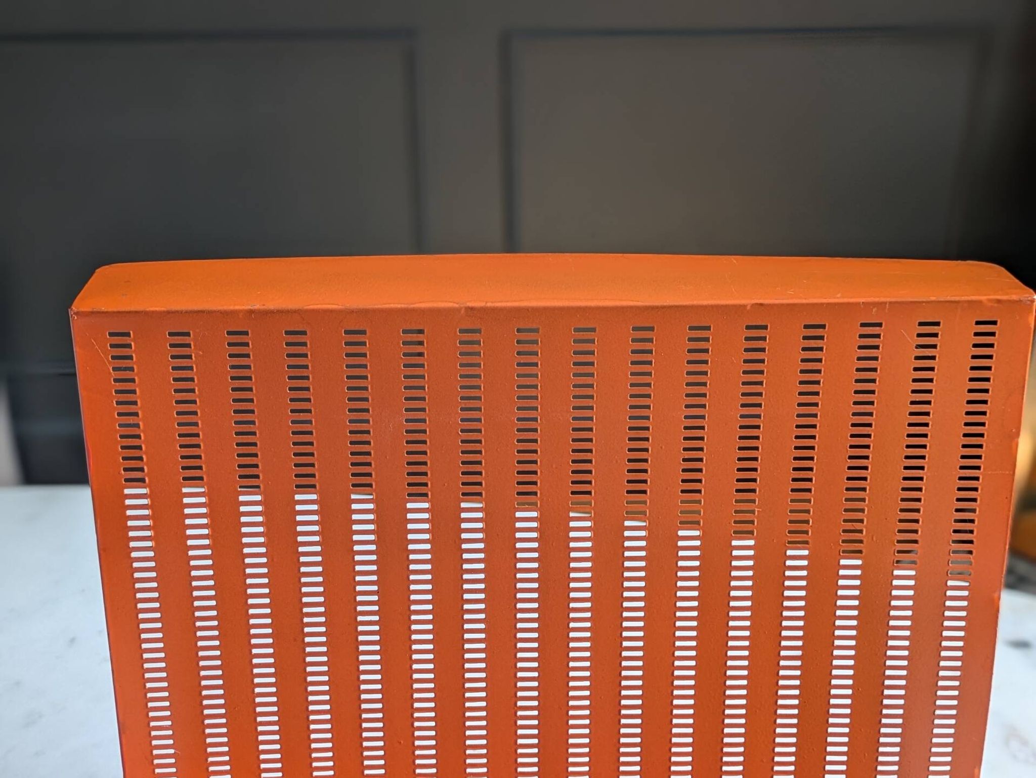 Vintage metal magazine rack in perforated orange/Mathieu Mategot style/70s