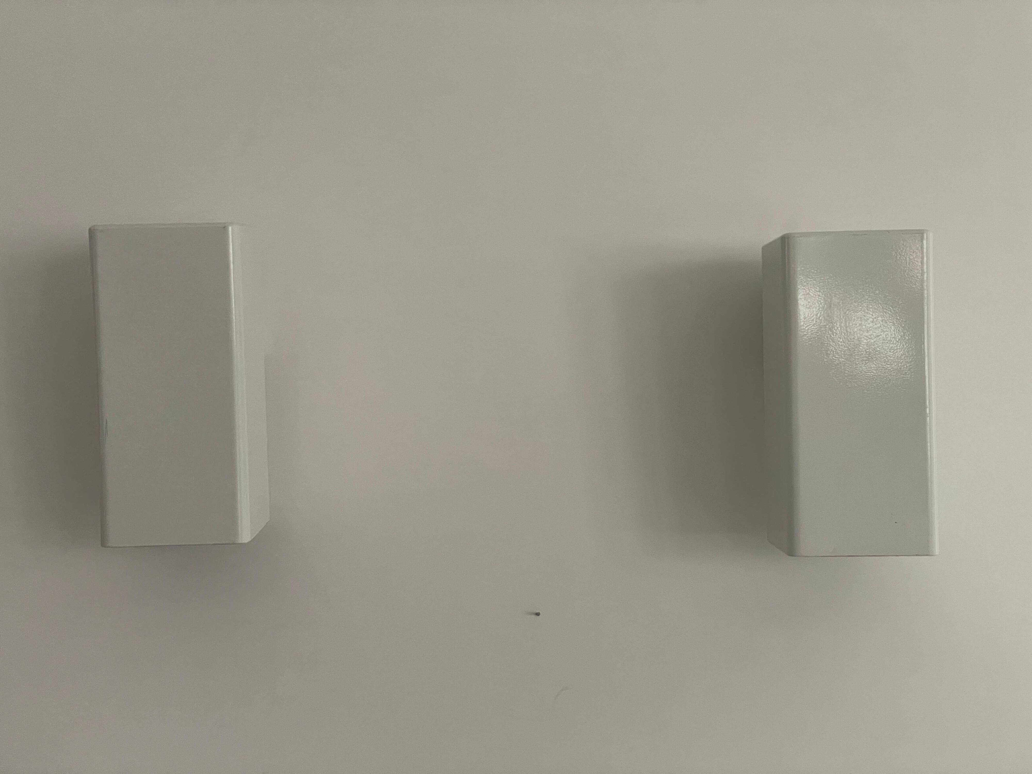 Pair of minimalist white metal wall lights from the mid-century, 1960, Germany.