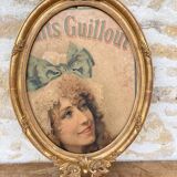 Old oval frame in wood and gilded stucco