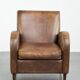 Sheepskin armchair in a light cognac colour with matching piping