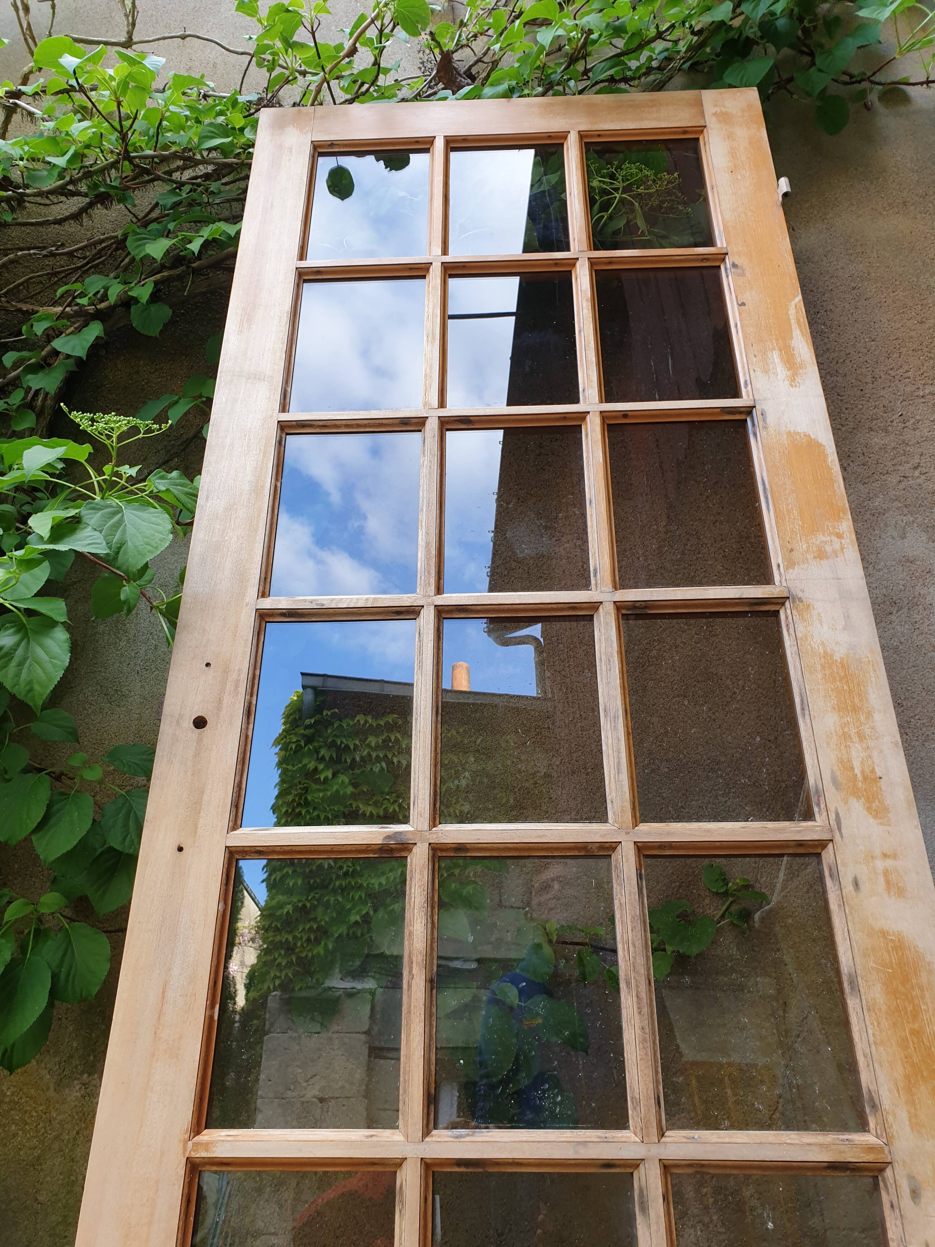 Old wooden door glazed with small tiles