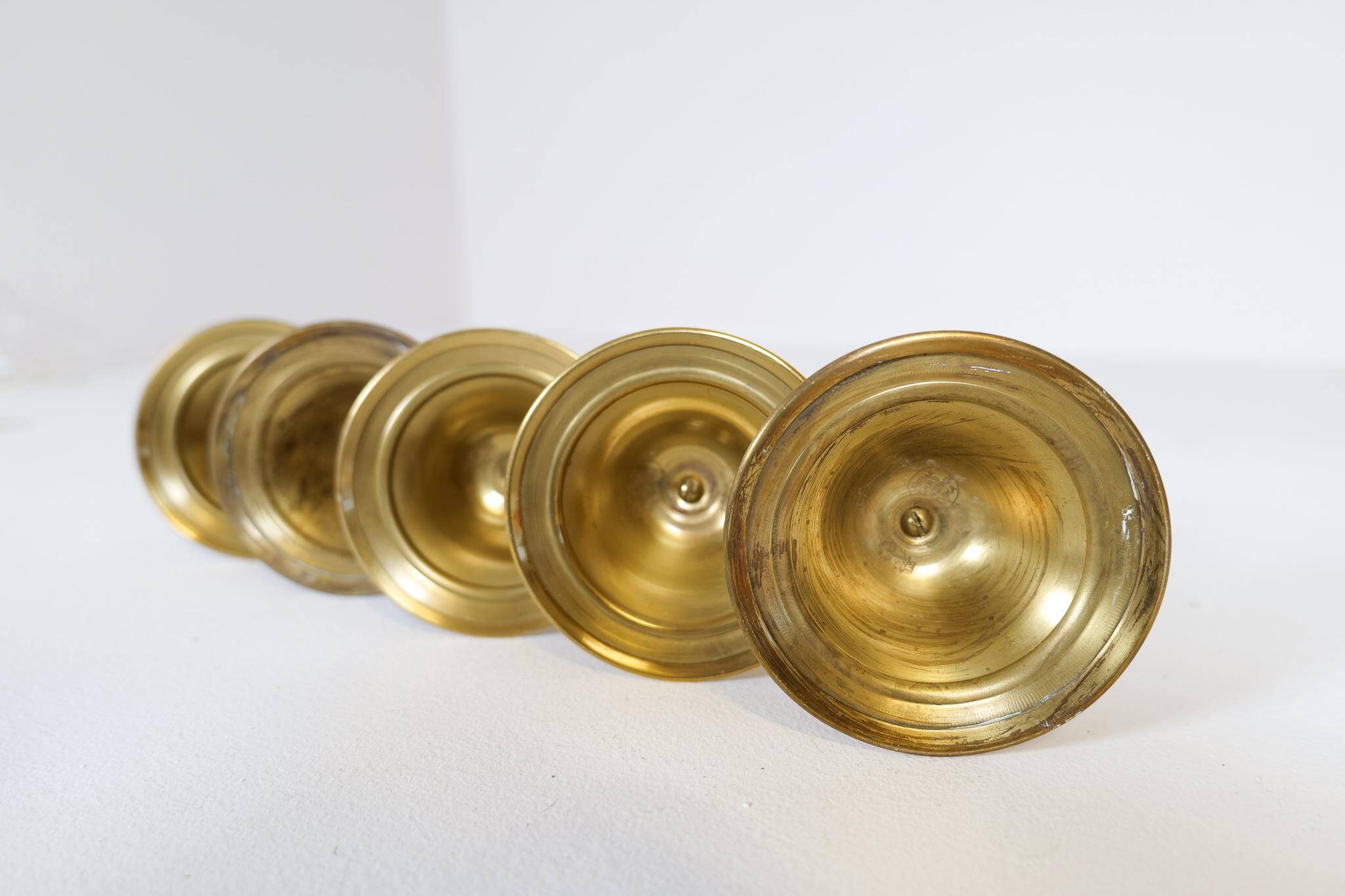 Mid-century set of 5 brass candlesticks by Lars Holmström, Arvika, Sweden.