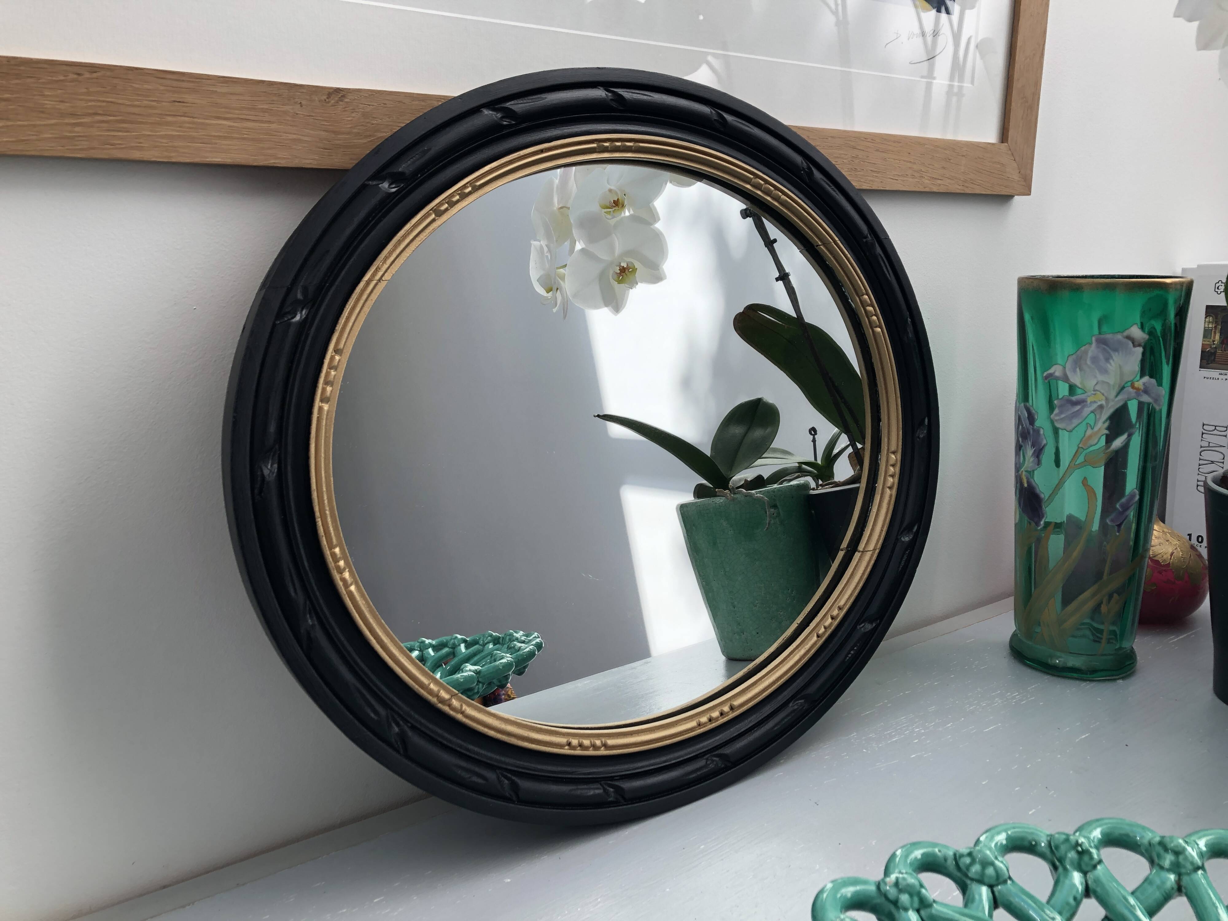 black and gold oval mirror