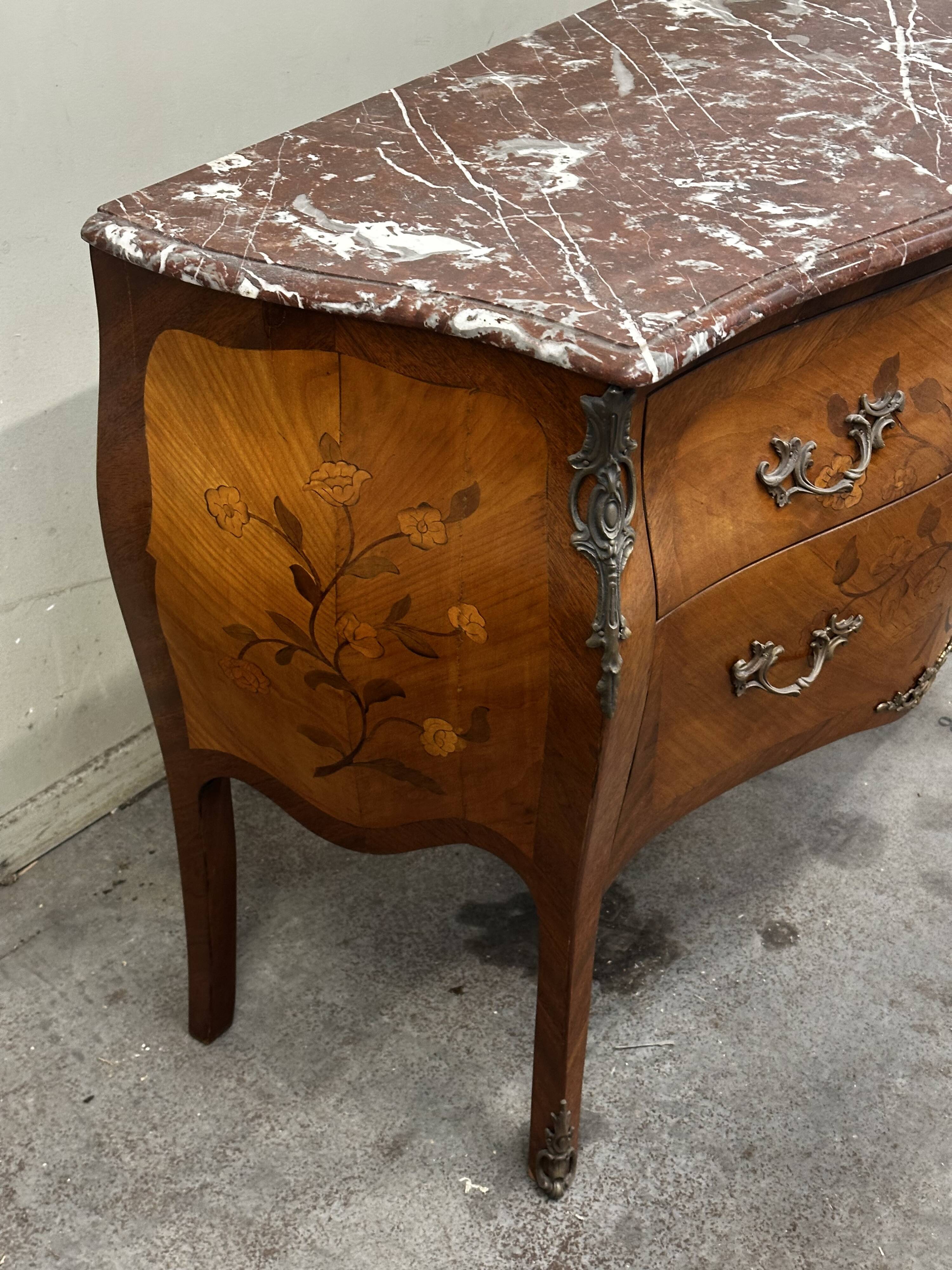 Curved and inlaid Louis XV style chest of drawers