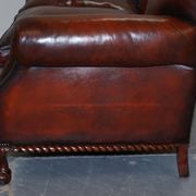 Restored Victorian sofa in leather with claw feet and feather cushions.