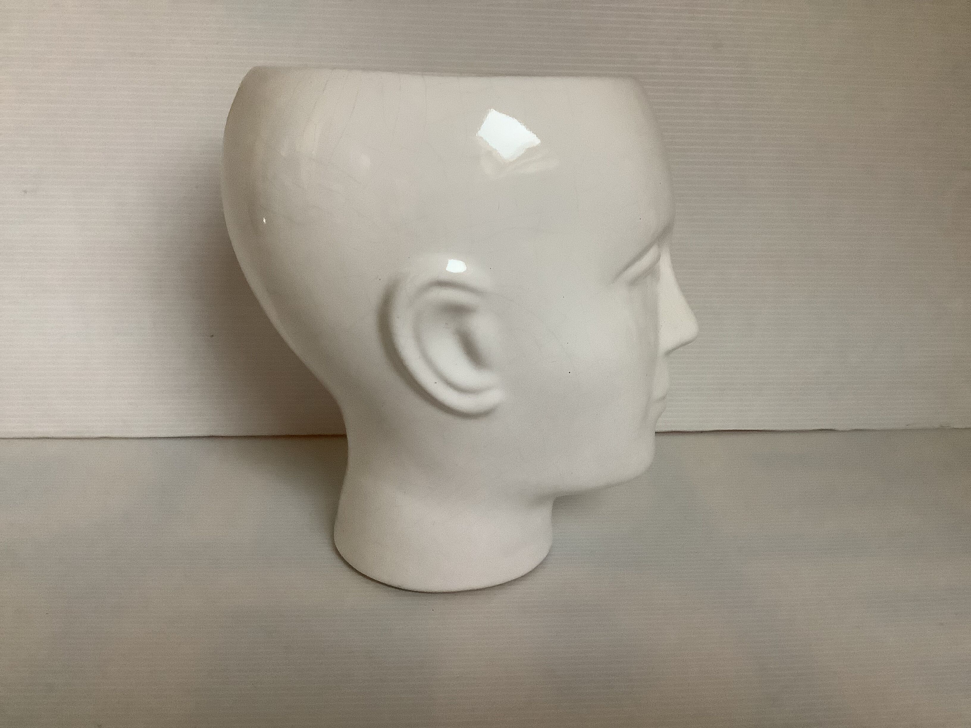 Man's head hide pot vase