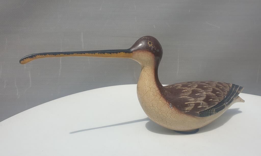 Carved painted wooden curlew