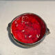Deep red glazed and metallic ceramic catchall.