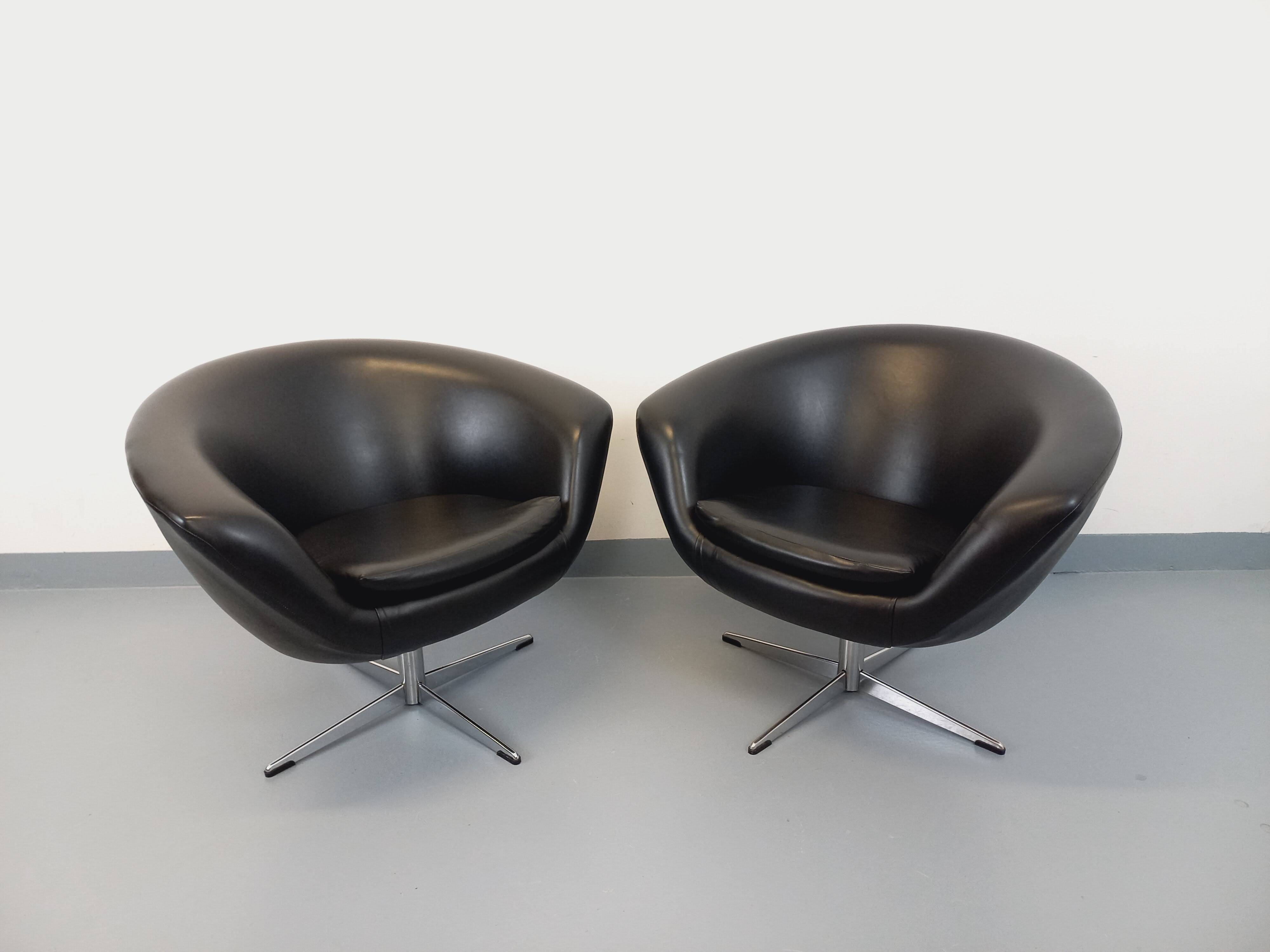 Pair of vintage Scandinavian swivel armchairs in faux leather and chrome.
