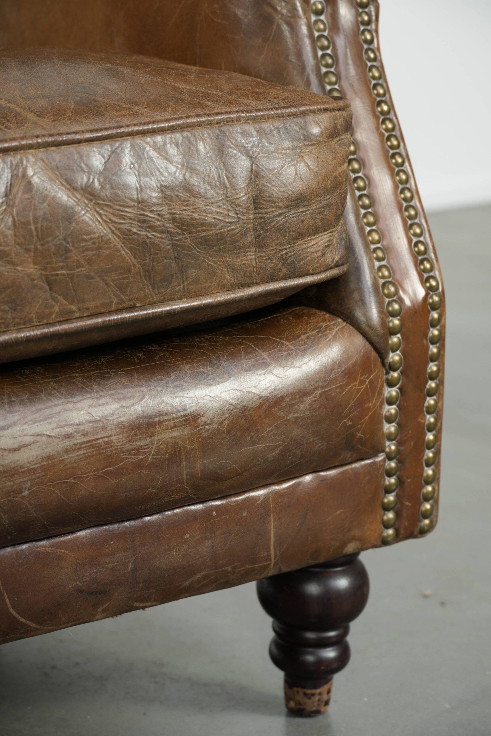 Robust cowhide armchair in a beautifully subtle size with a wonderful patina.