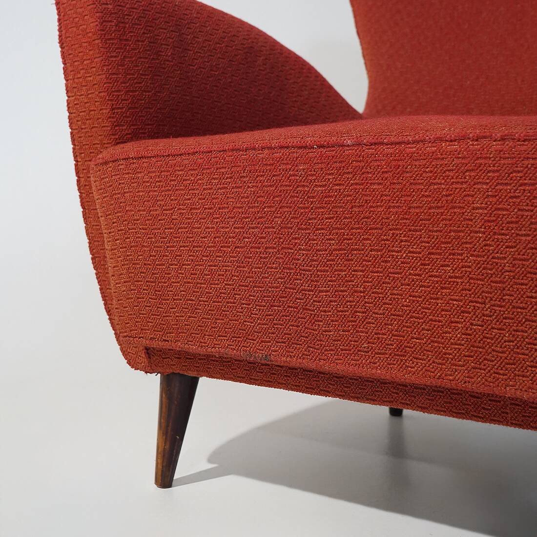 Pair of red armchairs with cone-shaped feet, 1950s