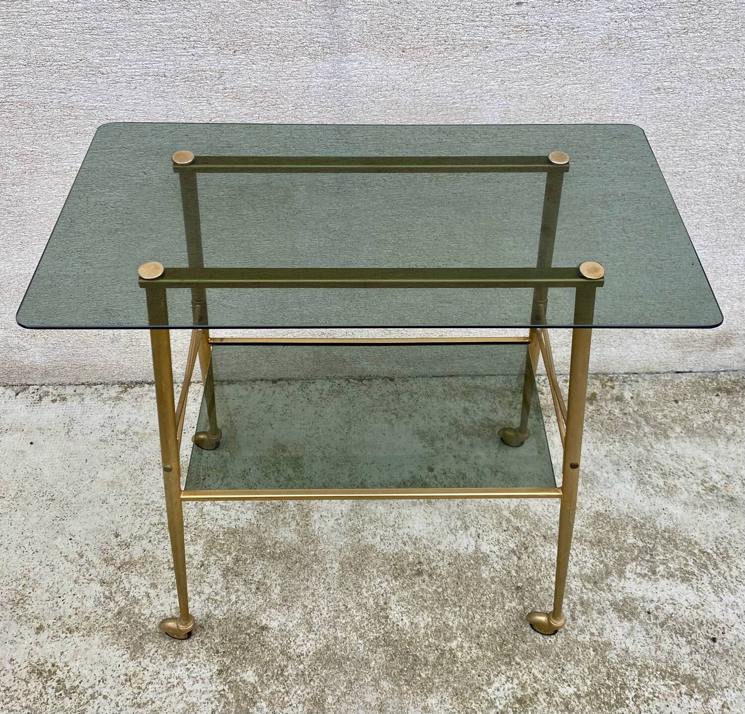 Vintage 1970s glass and gold rolling console table.