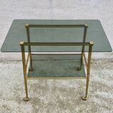 Vintage 1970s glass and gold rolling console table.
