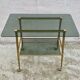 Vintage 1970s glass and gold rolling console table.