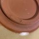 Decorative glazed terracotta plate with olive leaf pattern.