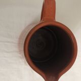 Orange glazed ceramic pitcher