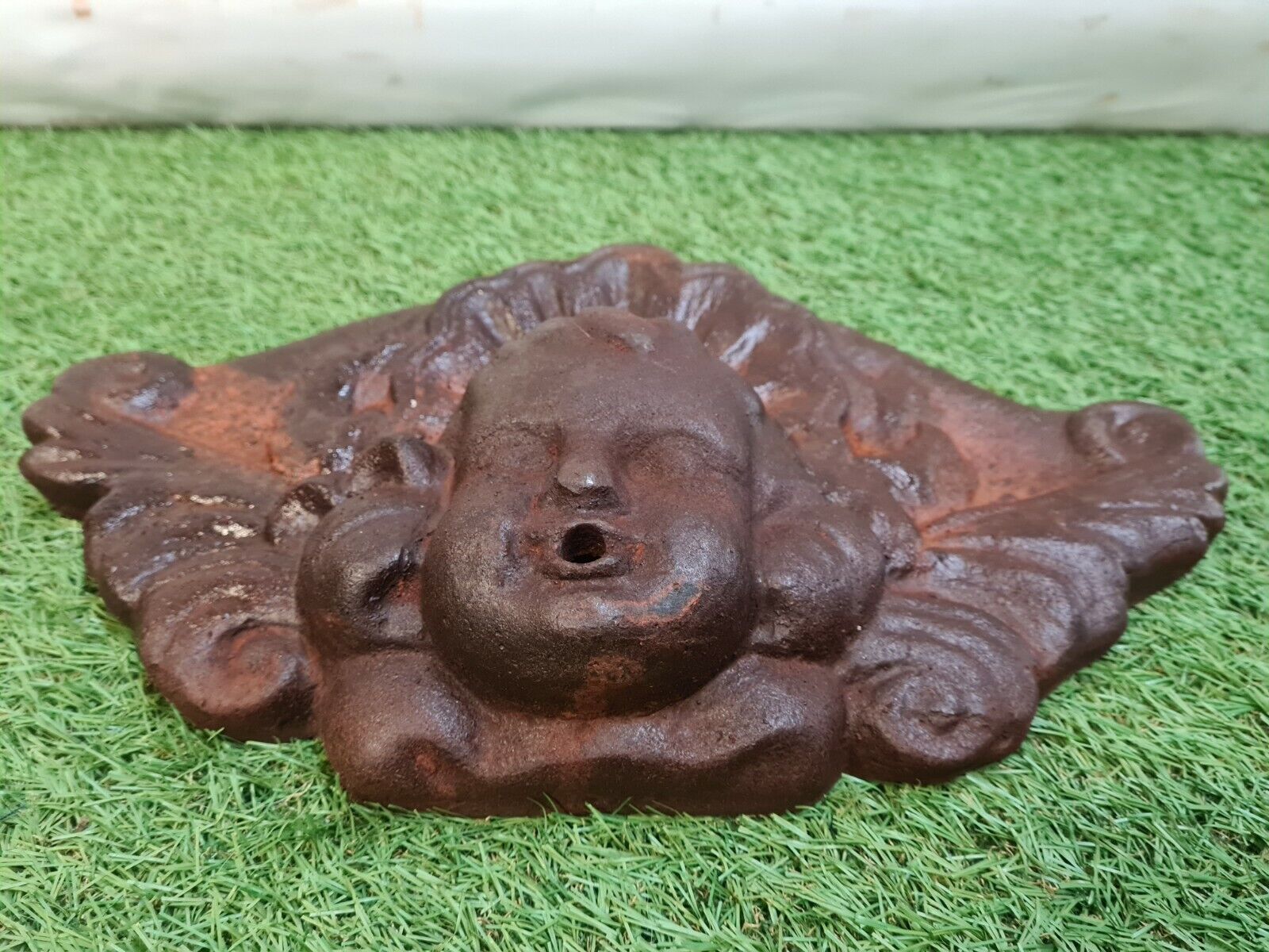 Cast iron wall fountain with a love