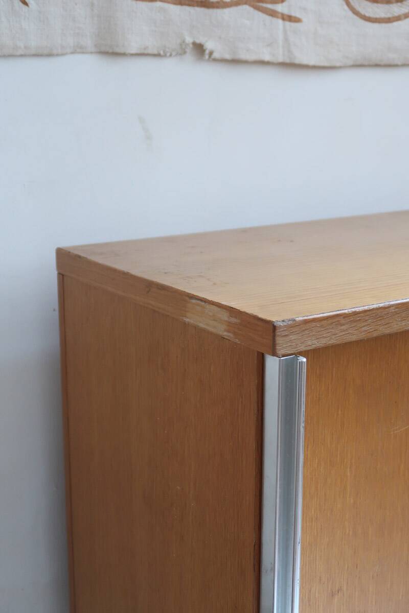 1970s low furniture in wood and metal with sliding doors.