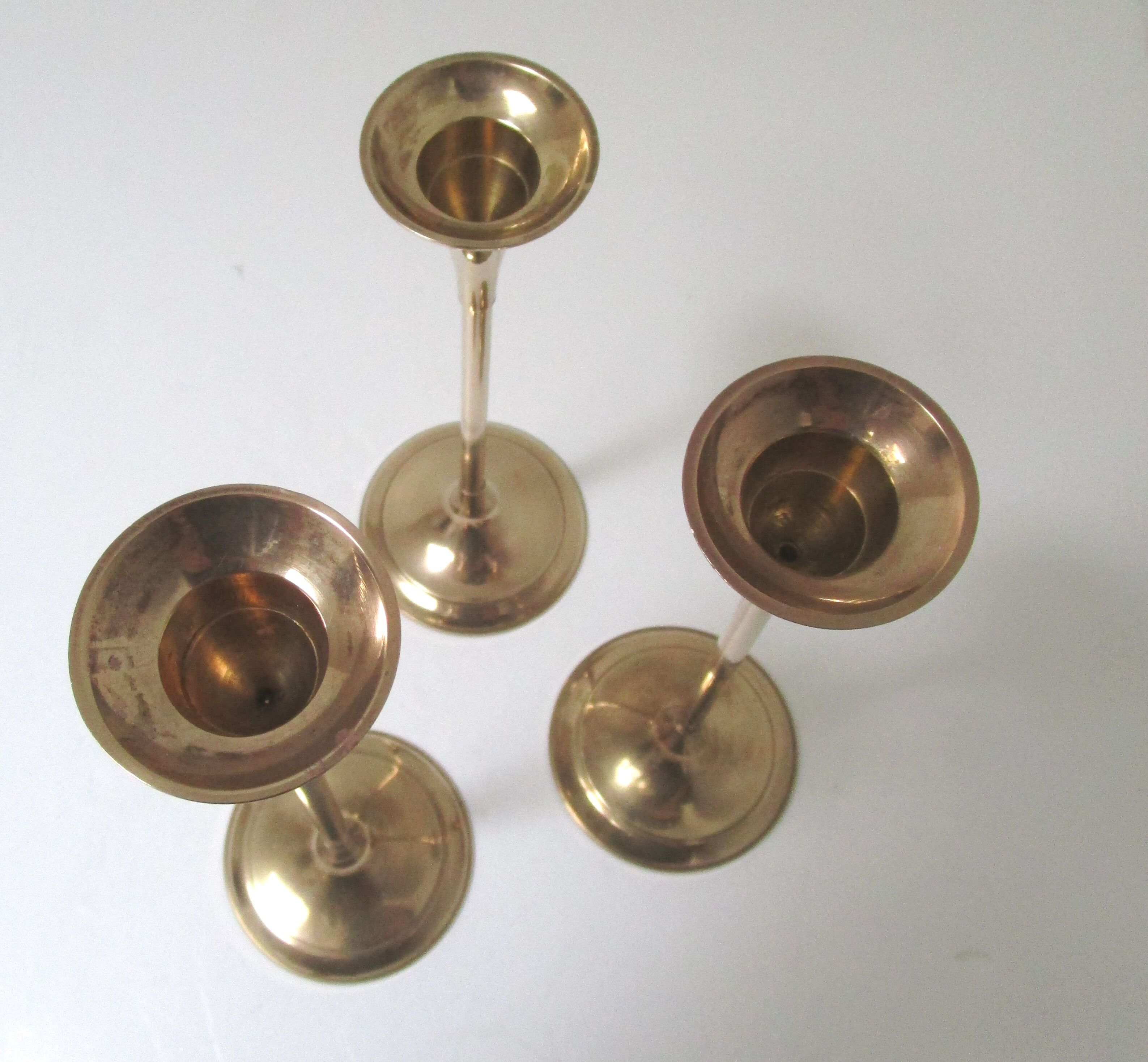 Trio of brass scandinavian candlesticks