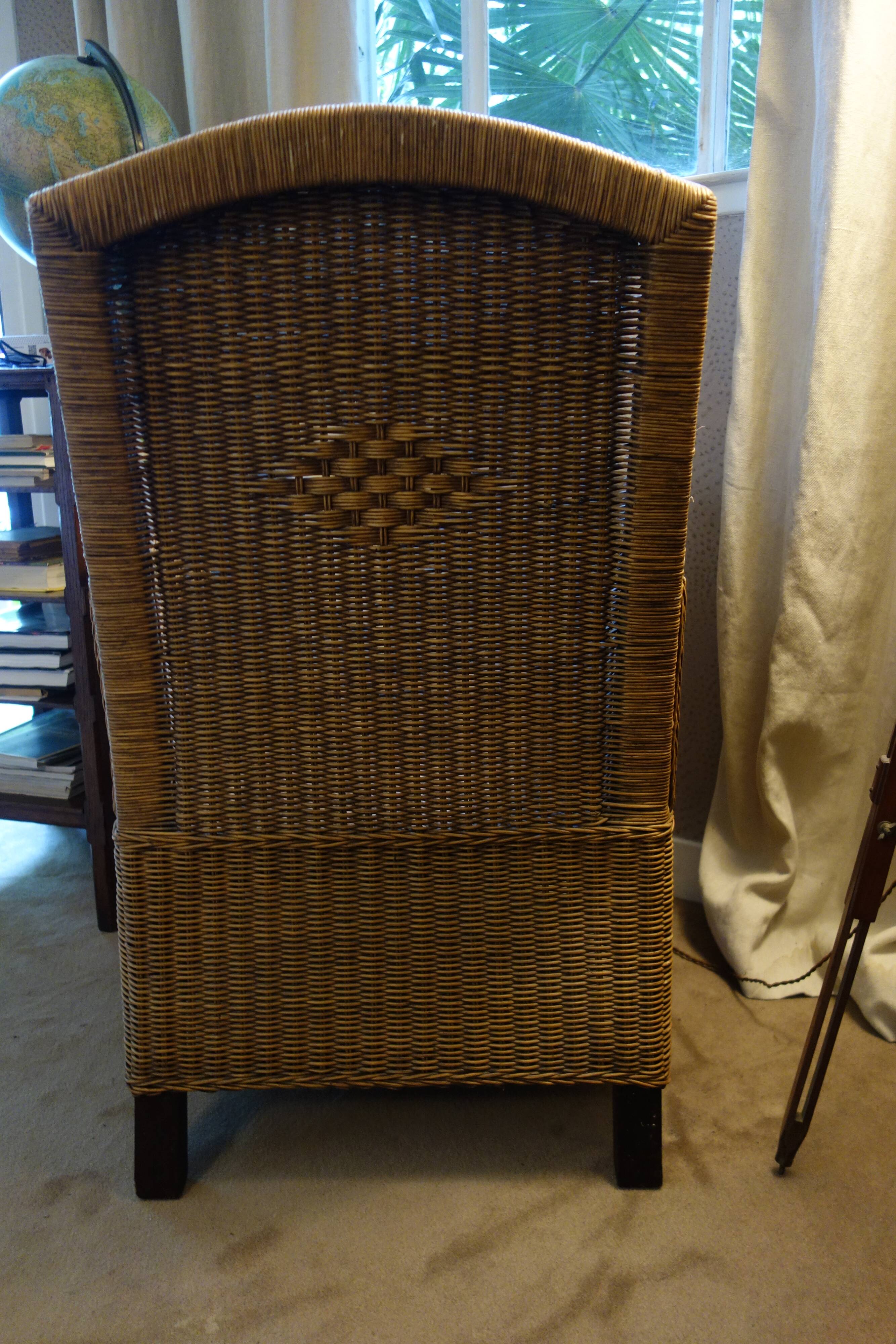 comfortable colonial-style armchair in rattan and mahogany