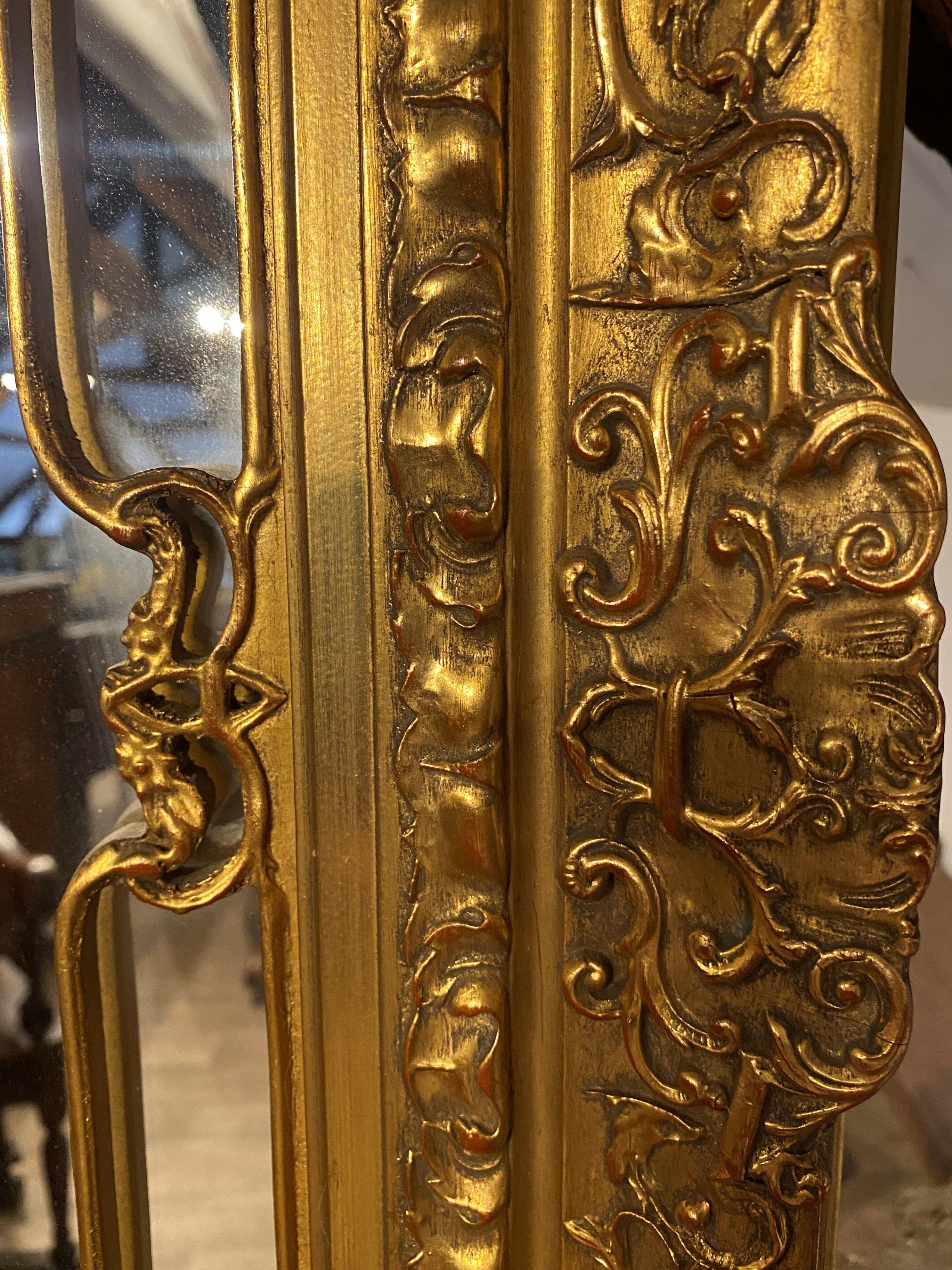 Wooden mirror with gilded stucco