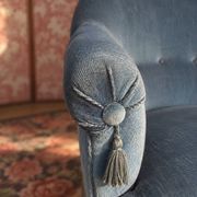 Vintage blue velvet frog chair, a timeless comfortable piece.