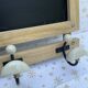 Wall-mounted coat rack with porcelain hooks