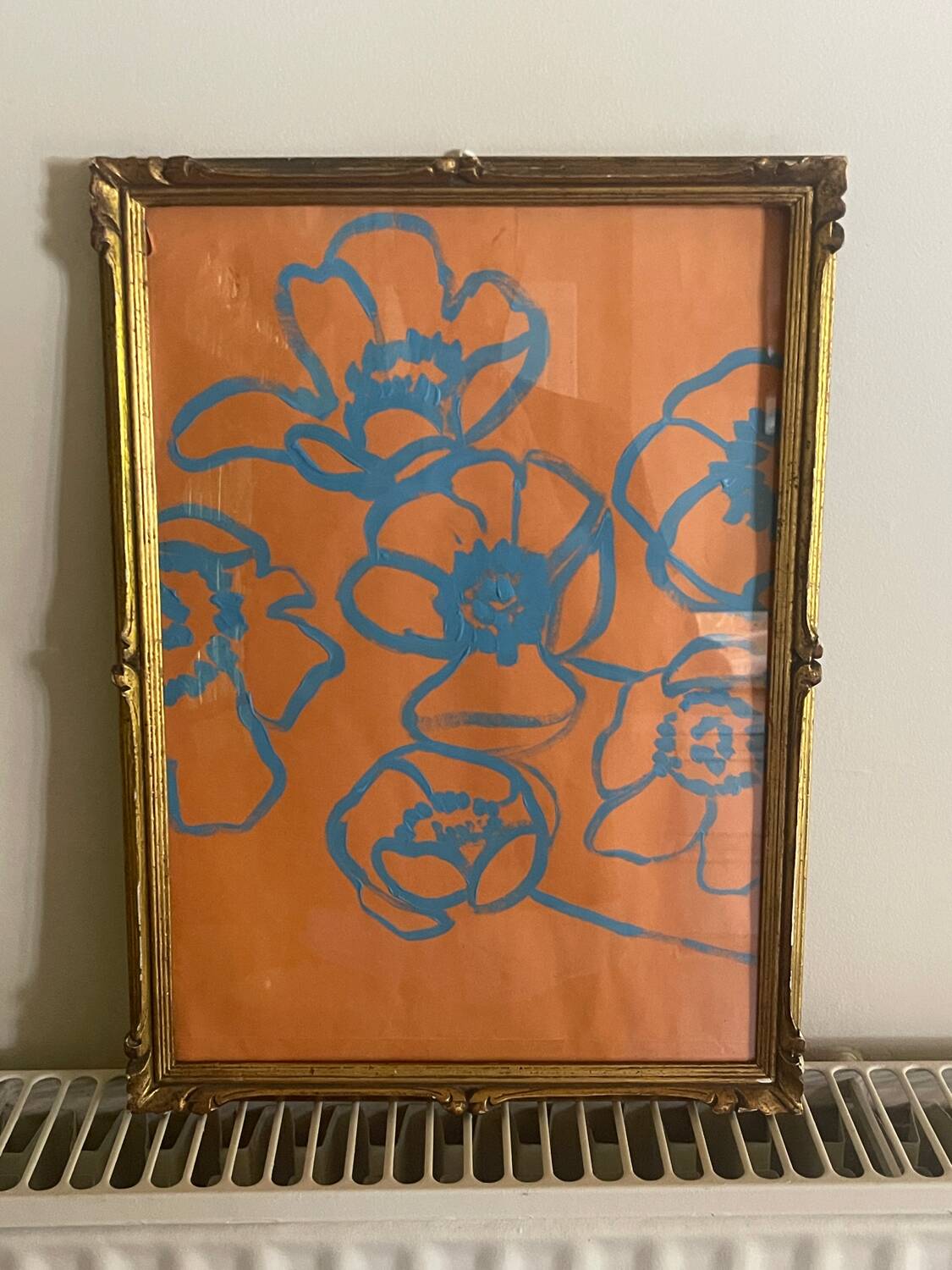 Gouache painting of blue flowers on an orange background