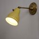 Wall lamp inlaiton and pale yellow lacquered metal