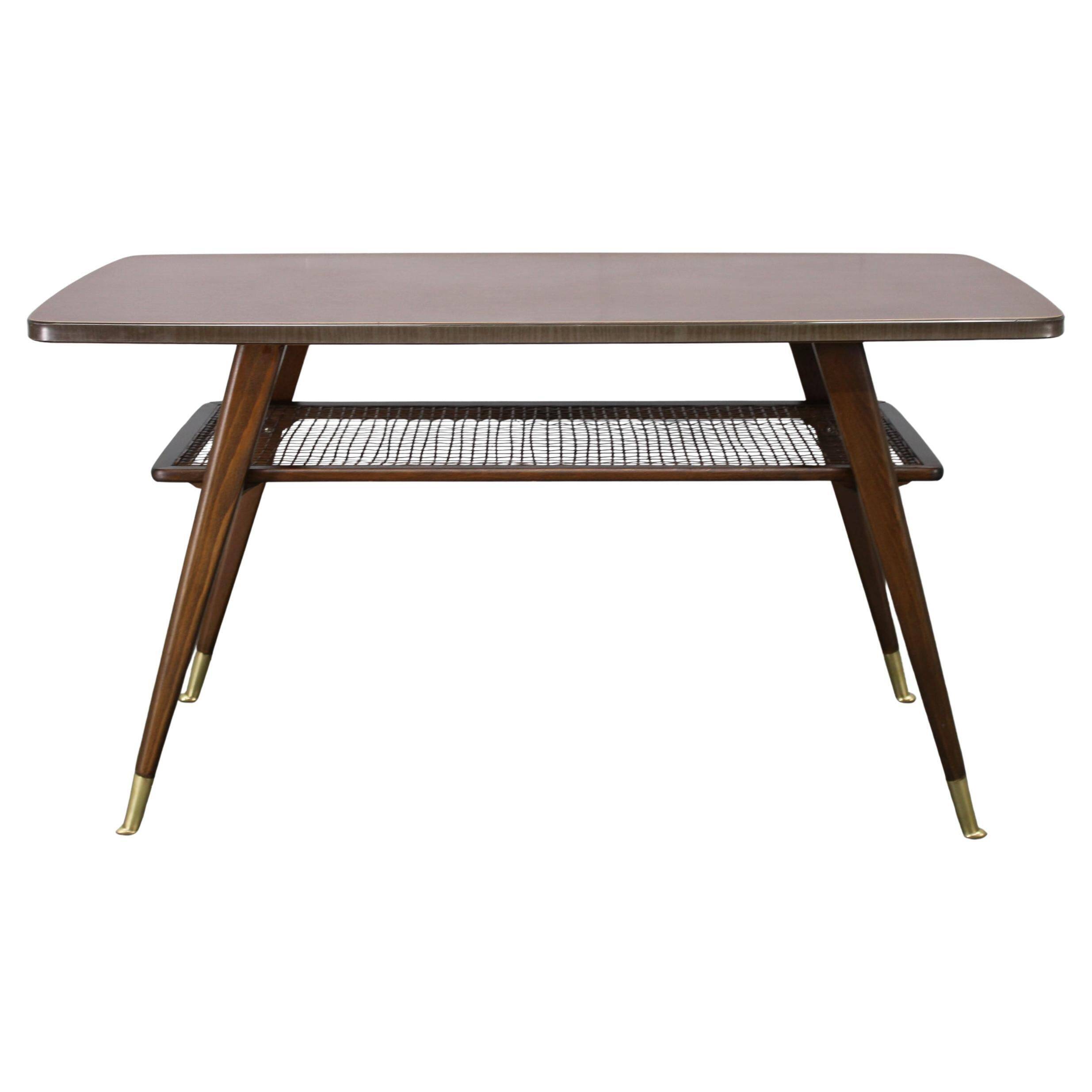 Mid-century German coffee table with rattan shelf and brass legs