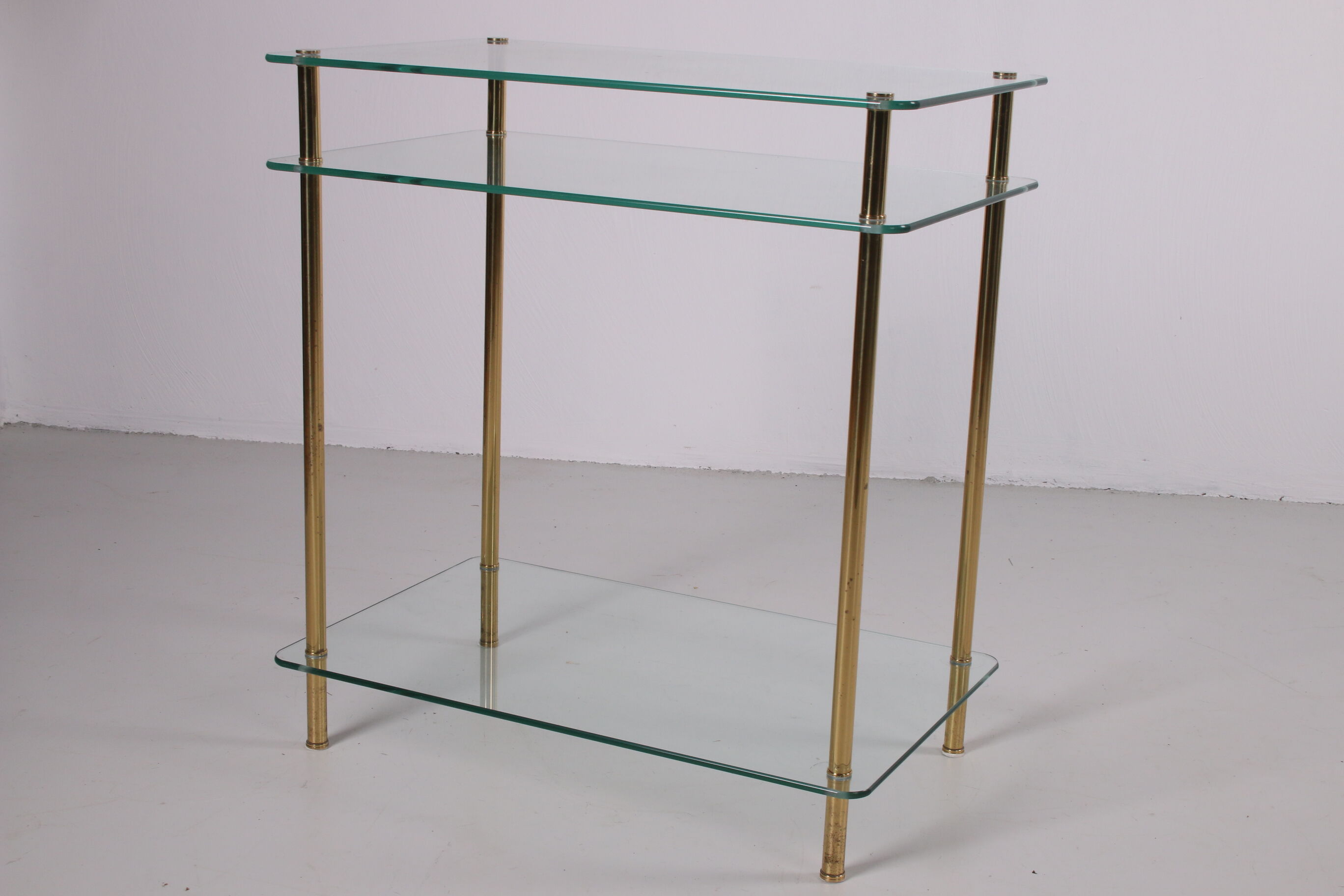 Hollywood Regency side table with gold-colored legs