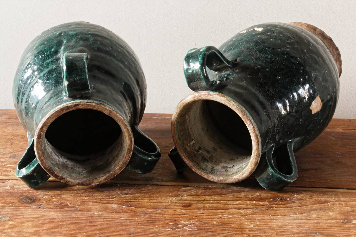 Set of two Chinese green glazed stoneware storage jars.