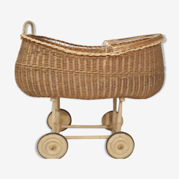 Vintage rattan cradle or pram on wheels