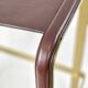 Contemporary kitchen stool, aged brass metal and cognac leather.