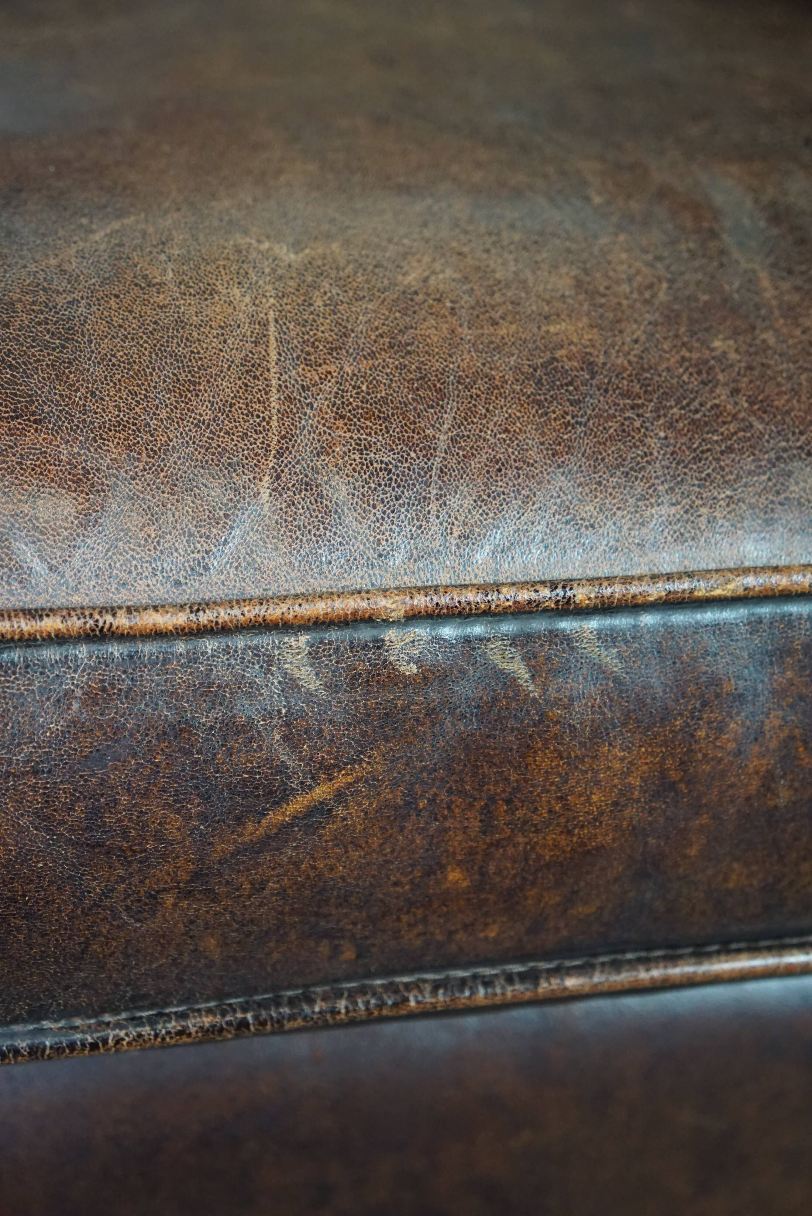 Dark sheep leather club armchair, sleek design